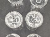 six clear plastic cups with lids are sitting on a table