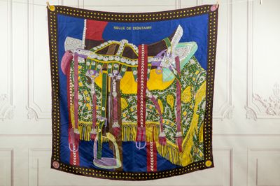 a colorful tapestry hanging on a wall in a room