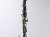 a close up of a silver and black saxophone on a white background