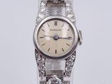 an image of a woman ' s wrist watch with diamonds on it