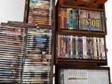 a lot of dvd ' s stacked on top of each other