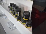 several jars of honey sit on a white shelf in a room