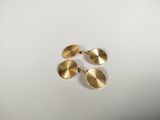a pair of gold cufflinks on a white surface