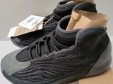 a pair of black and grey sneakers sitting on top of a box