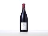 a bottle of red wine sitting on top of a table
