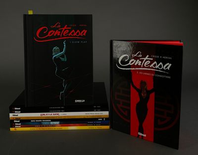three books are stacked on top of each other on a table