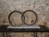 two rings sitting on a table in front of a brick wall