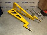 two pieces of yellow metal sitting on top of a table