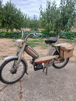 a moped that is parked on the side of the road