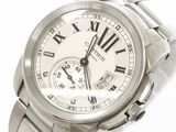 a silver wrist watch with roman numerals on it