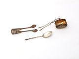 three spoons and a spoon rest on a white surface