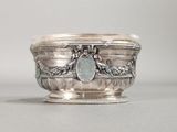 an antique silver bowl with a stone in the middle of it