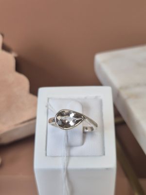 a white box with a silver ring in it on a table
