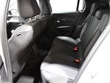 the back seats of a white car with black trims and a black seat belt