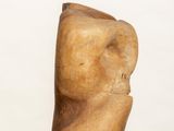an image of a wooden sculpture on a pedestal with a white background