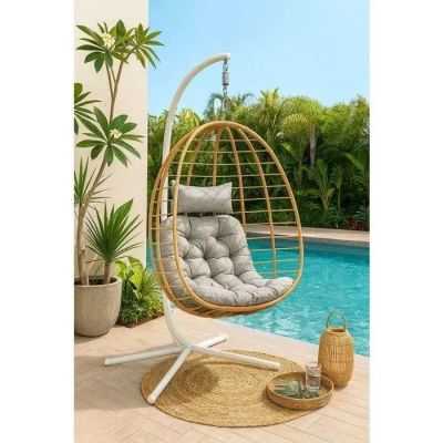 a white hanging chair next to a swimming pool