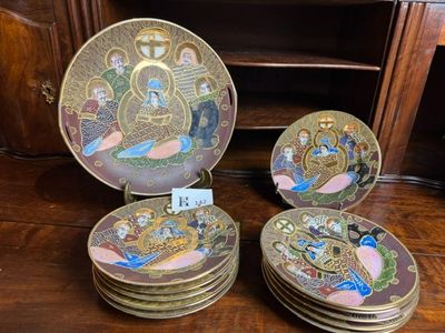 several plates with a picture of a person on them on a wooden table