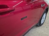 a close up of a car door handle with a sticker on it