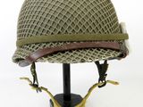 a close up of a helmet on a stand on a white background