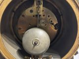 a close up of a clock that is on a stand