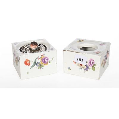 deux petites boîtes blanches ornées de fleurs, posées sur une surface blanche