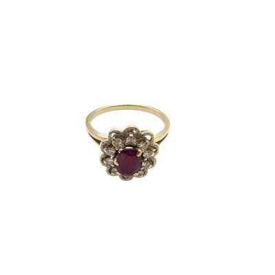 a close up of a gold ring with a ruby stone