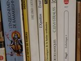 a lot of books that are on a shelf together