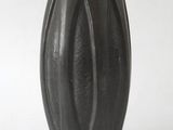 a black vase that has a price tag on it