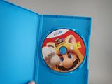someone is holding a blue case with a wii game inside of it