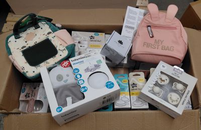 une boîte remplie d'articles pour bébé posée par terre