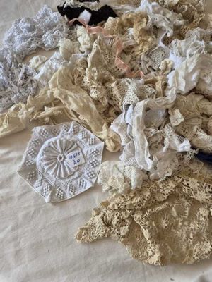 a lot of laces on a bed spread out on the bed