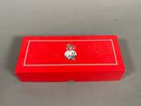 an image of a red box with a silver emblem on it