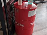 a red barrel sitting next to a red trash can