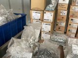 many boxes of screws and nuts on the floor