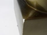 a close up of a metal object on a white surface