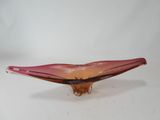 purple and red glass bowl sitting on top of a white table