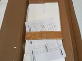 a box that has some papers in it on a table