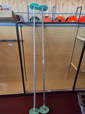 a metal rack with two green wheels in a room