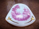 an image of a pink and white plate with a picture of a castle on it