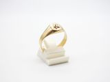 a close up of a gold ring on a white surface
