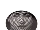 black and white photograph of a plate with a face on it