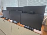 three televisions sitting on top of each other on a desk