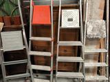 a lot of ladders that are sitting in a room