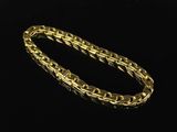 a gold bracelet on a black background