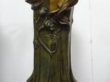 a statue of a woman holding a vase on a table