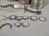 a lot of silver rings and other silver items on the table