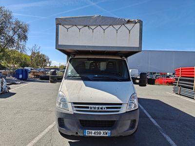 a white truck with a box on top of it in a parking lot