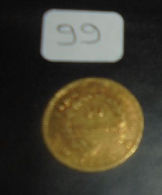 une pièce d'or sur laquelle figure le chiffre 35