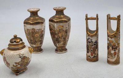 four vases and a teapot sitting on a table