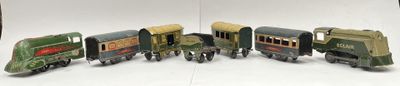 several toy trains are lined up in a row on a white surface
